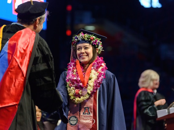 A Franke Honors graduate crosses the stage at McKale Center