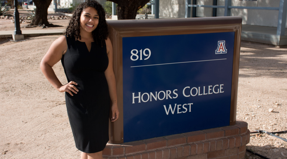 Leah Crowder in front of Honors College Sign