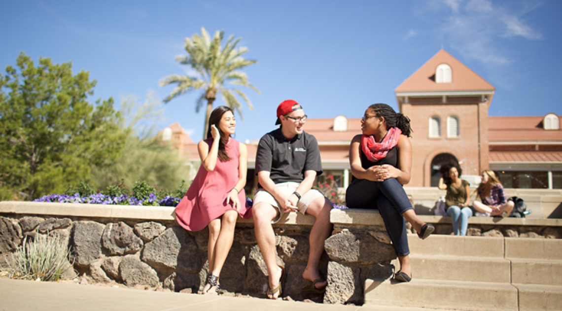Three students in front of Old Main on UA campus
